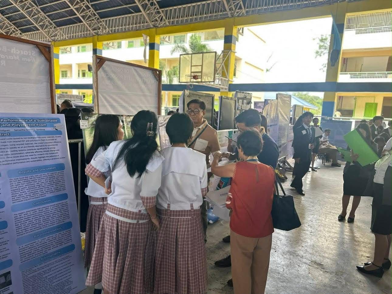 Visitors viewing student research posters during a school exhibit