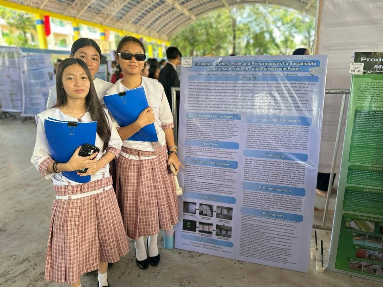 Teacher and student discussing a research poster