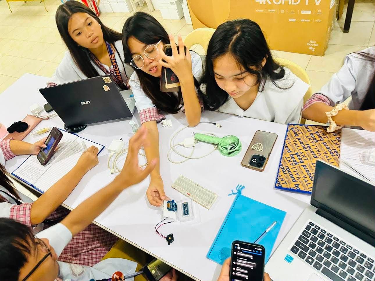 Students working together on an electronics and engineering activity