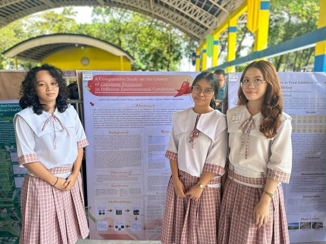 Student research team beside their completed exhibit poster