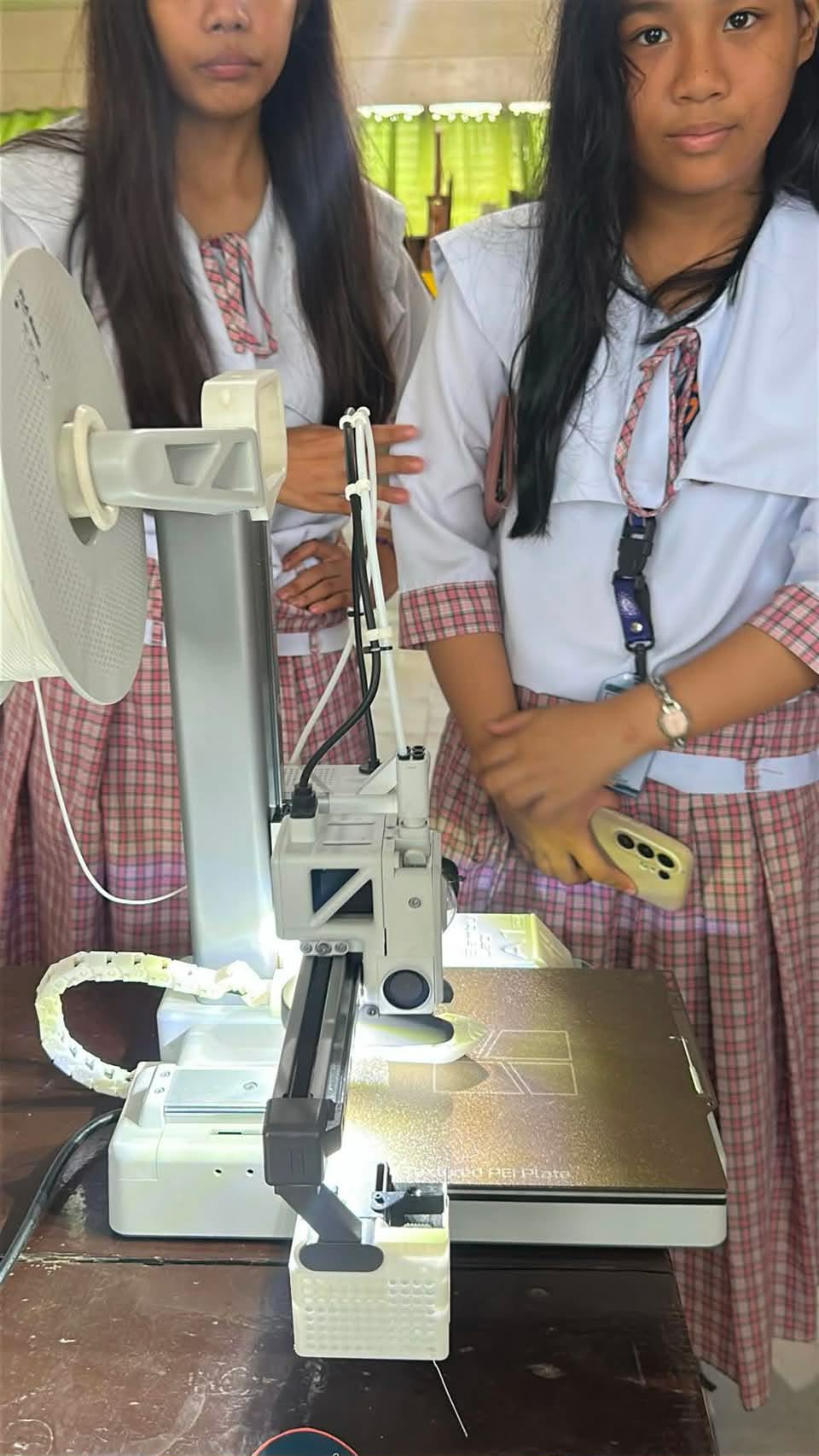Students presenting a vertical engineering model