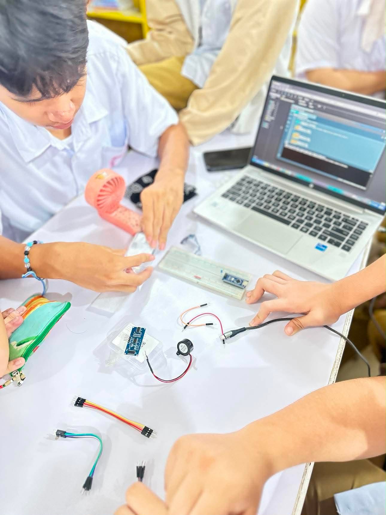 Teacher guiding students during a classroom investigation